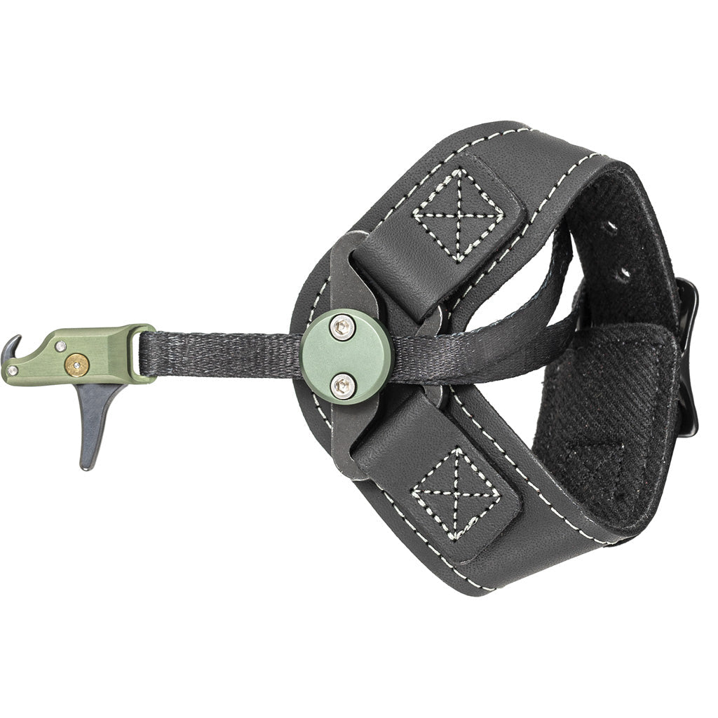 Wrist-strap release aid lying flat on a white background, black leather-and-mesh buckle strap on the right and a sage-green head with a small trigger on the left.